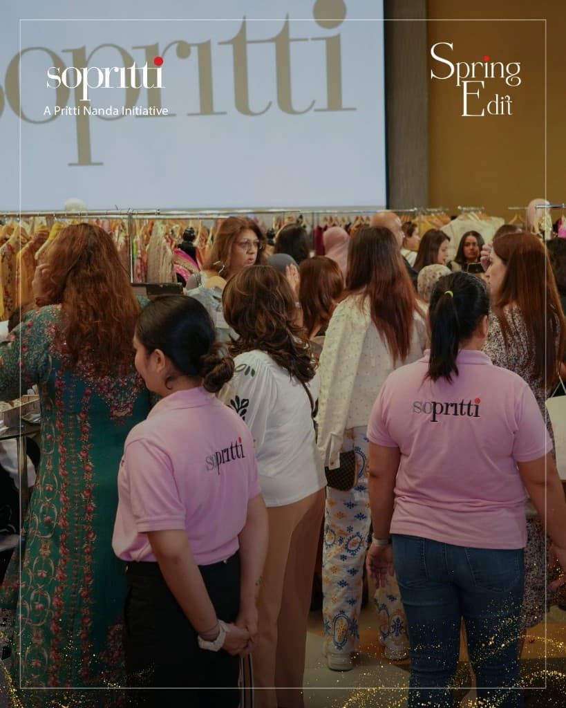 Sopritti Spring Edit — busy exhibition hall with clothing racks and team in branded polos