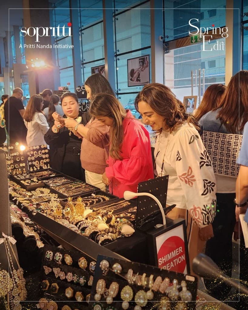 Sopritti Spring Edit — guests trying jewellery at an exhibition stall
