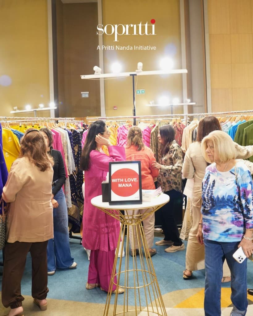 Sopritti exhibition — guests browsing designer wear in a bright ballroom