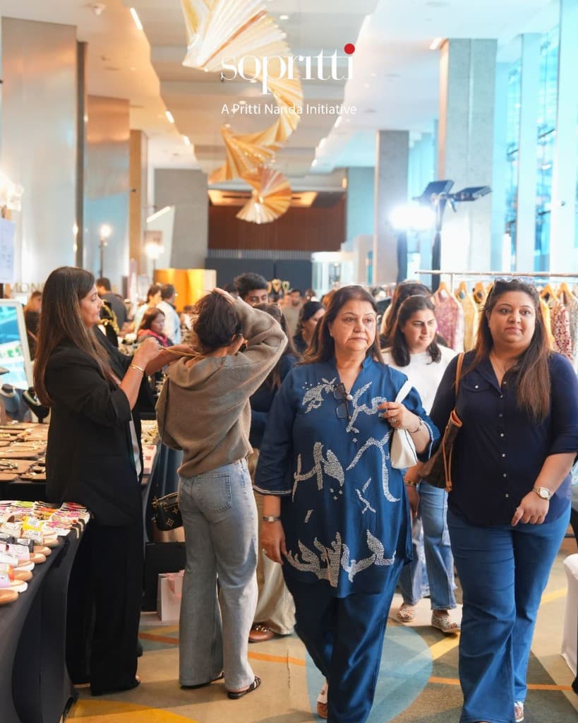 Wide view of a Sopritti multi-brand exhibition with sandals, jewellery, and apparel stalls