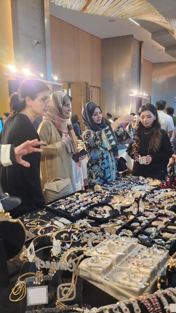 Sopritti team assisting a guest with jewellery at an exhibition stall