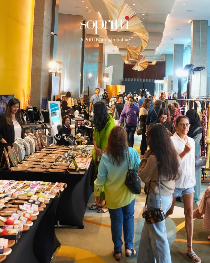 Guests admiring ornate gold jewellery at a Sopritti Spring Edit display in Dubai